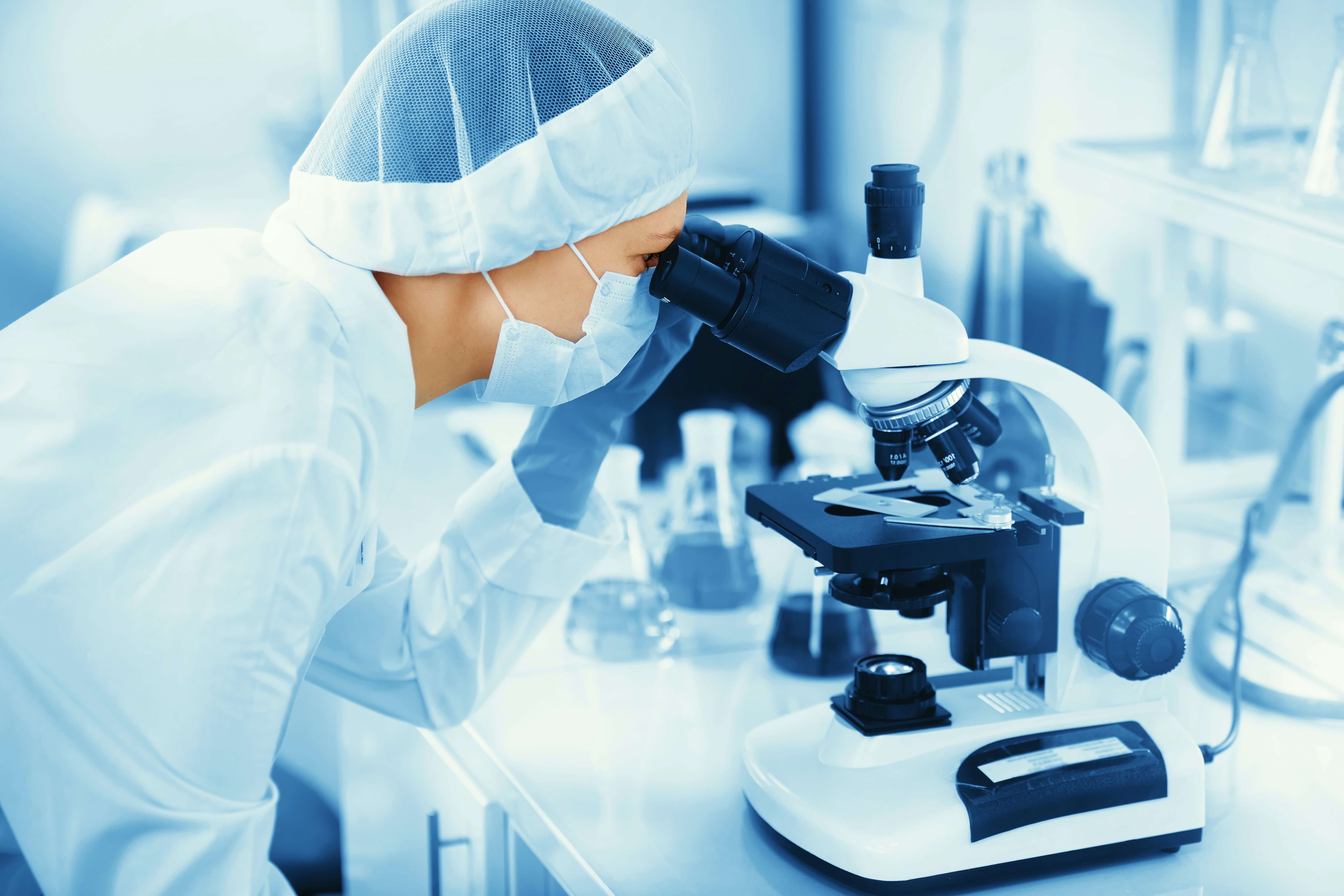 Laboratory research with microscope and glassware